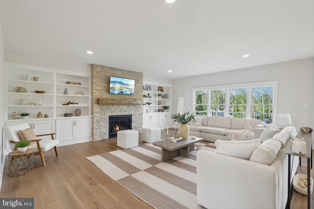 living room with a fireplace and light hardwood / wood-style floors