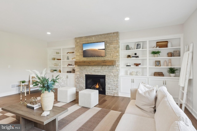 living room featuring a fireplace and light wood-type flooring