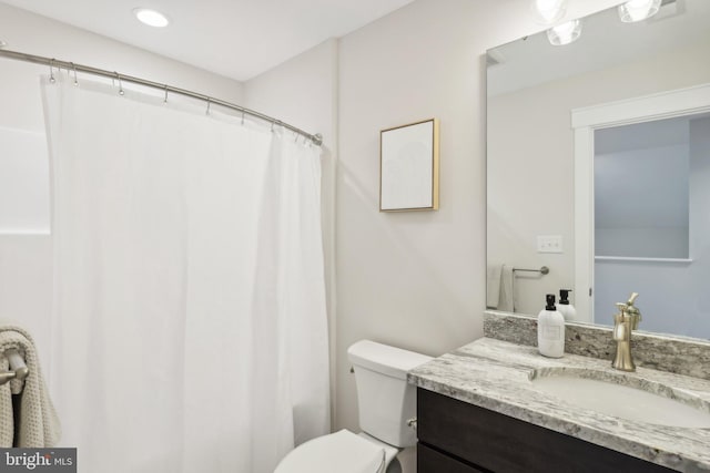 bathroom with vanity, toilet, and a shower with shower curtain