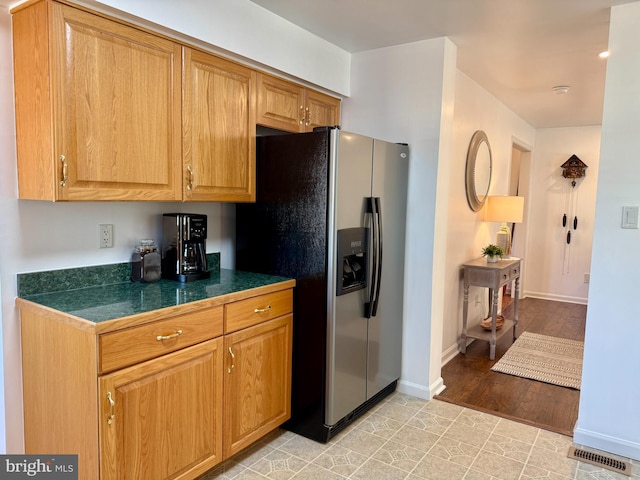 kitchen with stainless steel refrigerator with ice dispenser