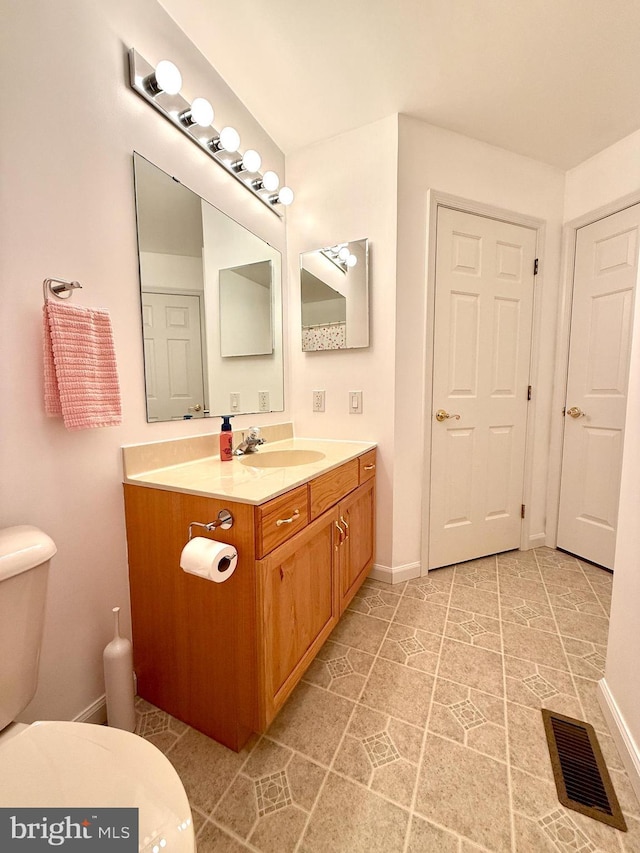 bathroom with vanity and toilet