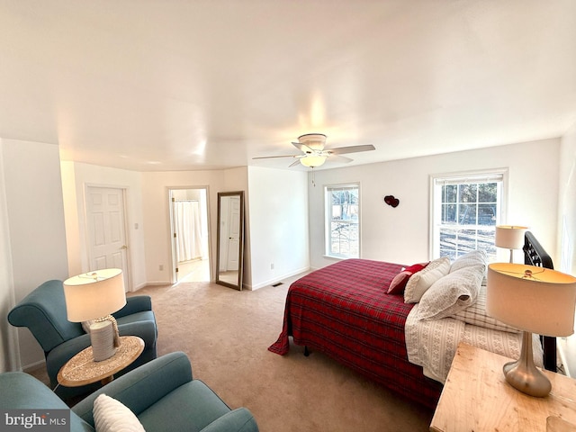 bedroom with ceiling fan and light carpet