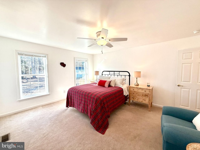 bedroom with ceiling fan and light carpet