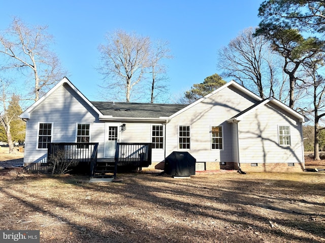 back of property with a deck