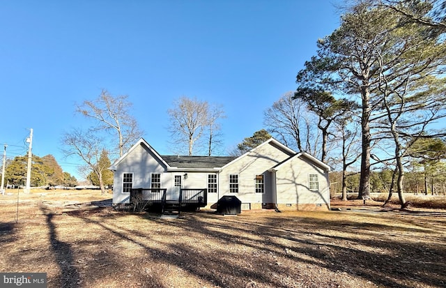 back of house with a deck