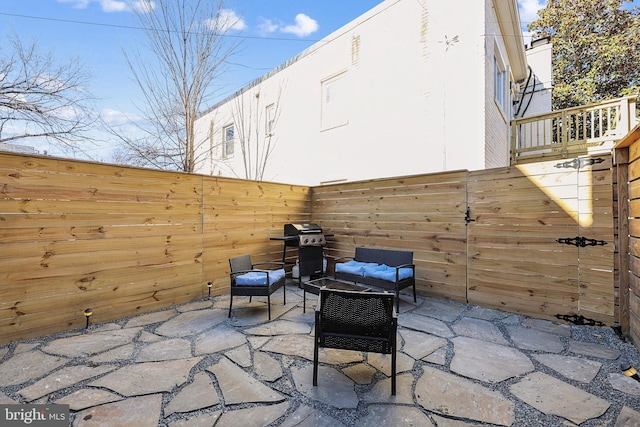 view of patio with area for grilling and outdoor lounge area