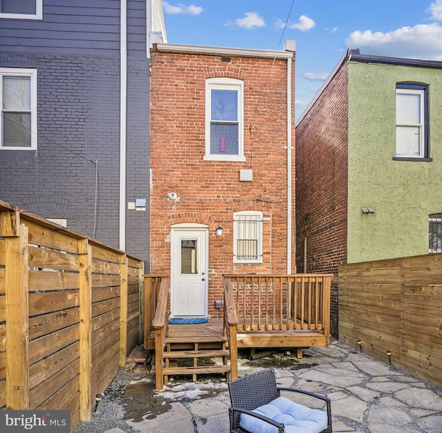 rear view of house featuring a patio and a deck