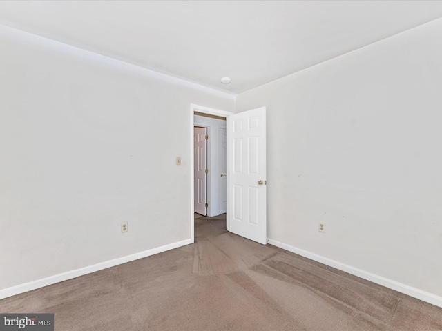 empty room with carpet flooring and baseboards