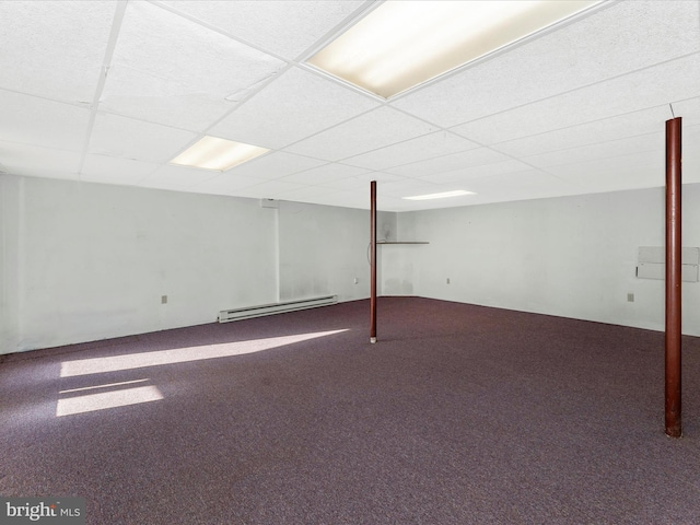 finished basement featuring carpet floors, baseboard heating, and a paneled ceiling