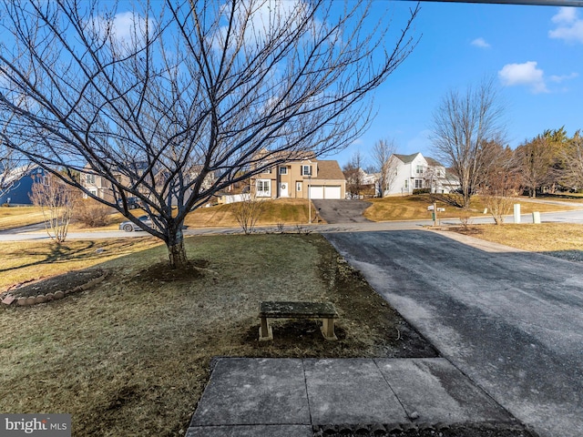 view of yard with a garage and a residential view