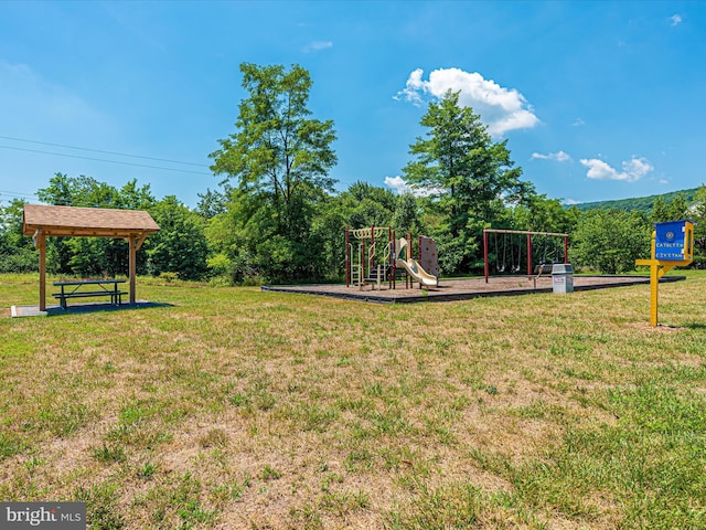 community jungle gym featuring a lawn