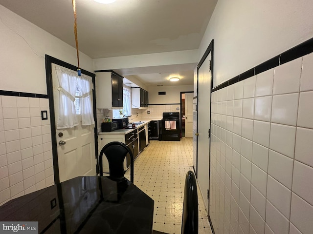 dining area featuring tile walls and sink