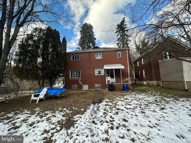 view of snow covered rear of property