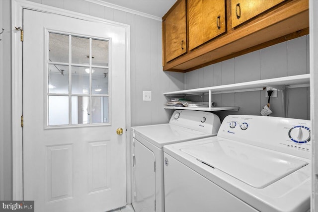 laundry room with cabinets and separate washer and dryer