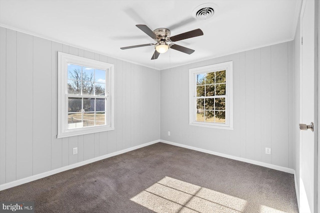 carpeted spare room with crown molding and ceiling fan