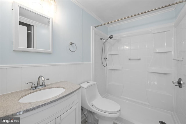 bathroom with vanity, crown molding, toilet, and walk in shower