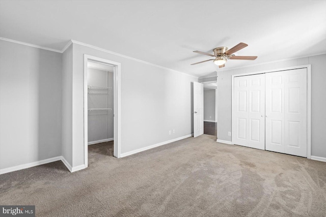 unfurnished bedroom with crown molding, carpet, and a closet