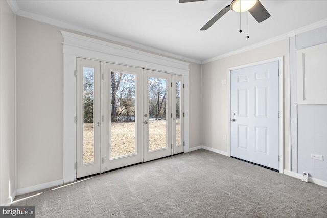 interior space with ornamental molding, light carpet, ceiling fan, and french doors