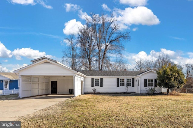 ranch-style home featuring a carport and a front yard