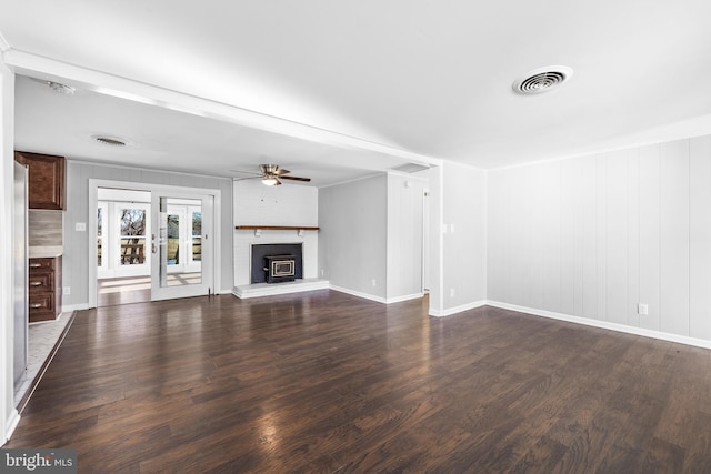 unfurnished living room featuring ceiling fan and dark hardwood / wood-style flooring