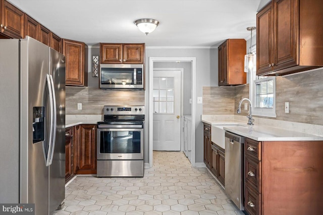 kitchen with sink, ornamental molding, pendant lighting, stainless steel appliances, and backsplash