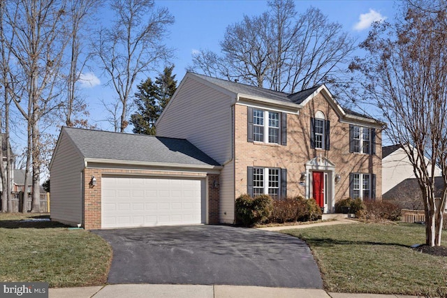 colonial-style house with a garage and a front lawn