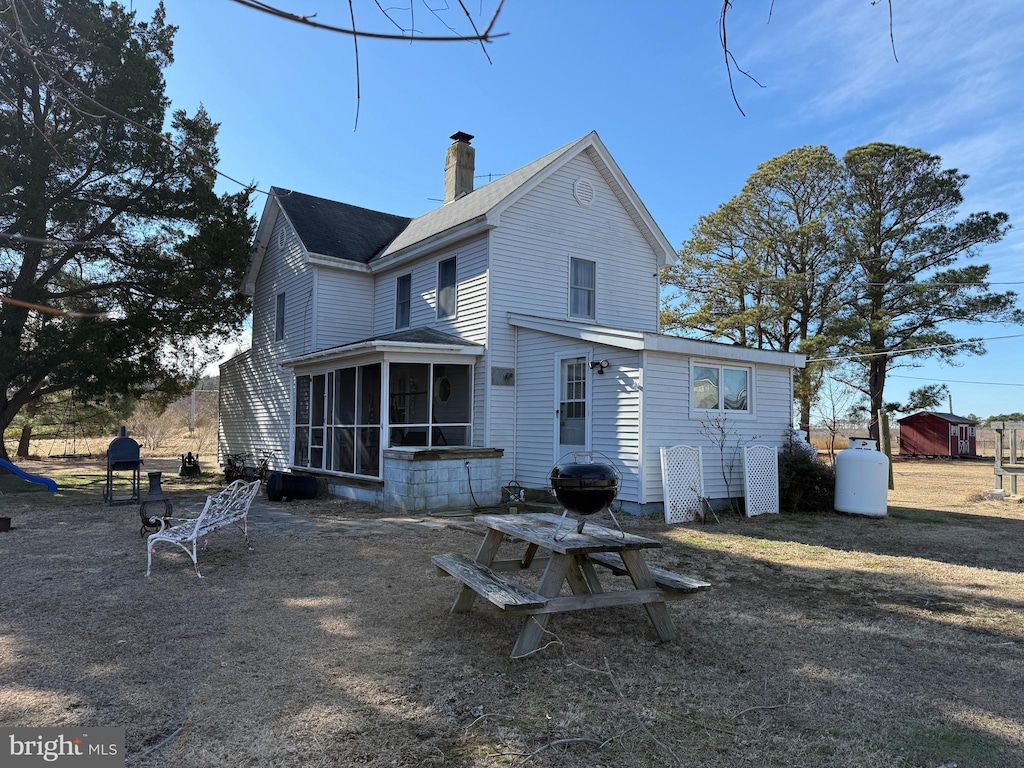 back of property featuring a sunroom