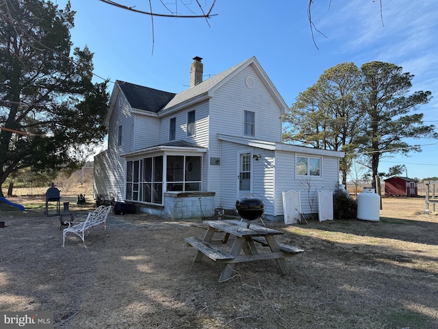 back of property featuring a sunroom