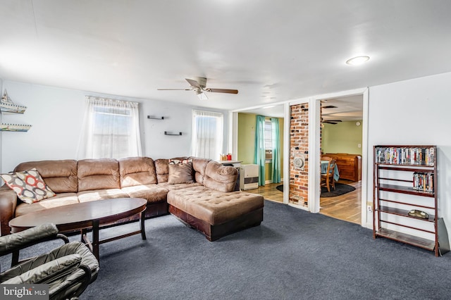 living room featuring ceiling fan and carpet