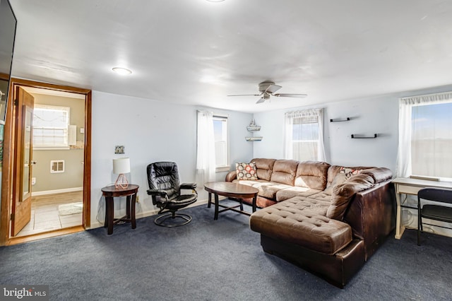 carpeted living room featuring a wealth of natural light and ceiling fan