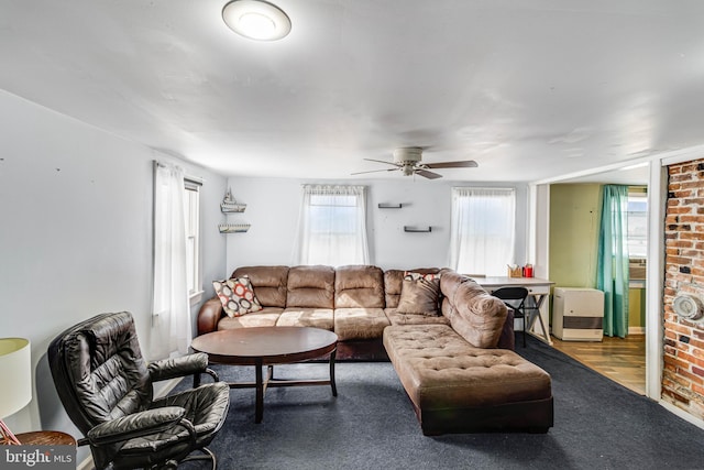 living room featuring ceiling fan and carpet