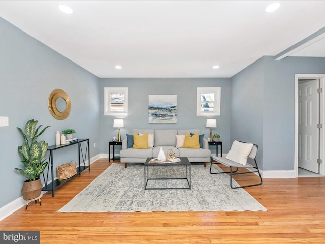 living room featuring recessed lighting, baseboards, and wood finished floors