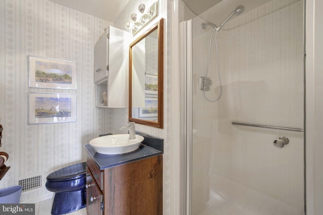 bathroom featuring a stall shower, vanity, visible vents, and wallpapered walls