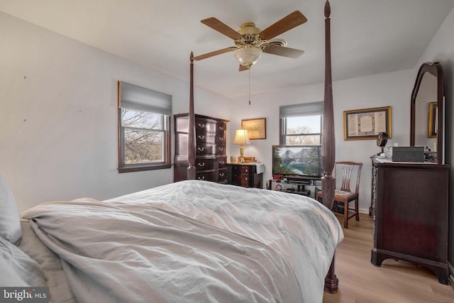 bedroom with light wood finished floors and a ceiling fan