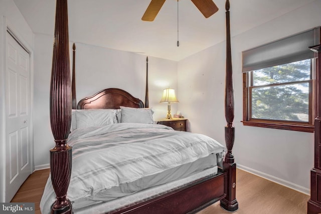 bedroom with baseboards, ceiling fan, and light wood finished floors