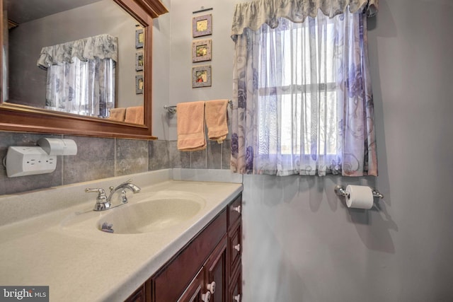 bathroom featuring vanity and decorative backsplash