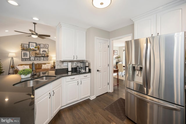 kitchen with sink, stainless steel fridge, white cabinetry, dark hardwood / wood-style floors, and tasteful backsplash