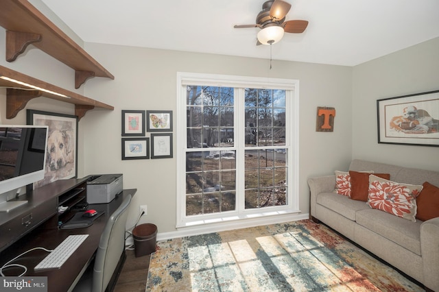 living room featuring wood-type flooring and ceiling fan