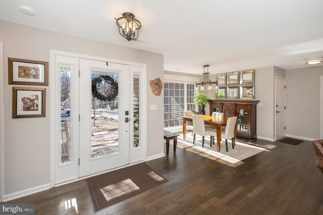 foyer featuring a notable chandelier and dark hardwood / wood-style floors