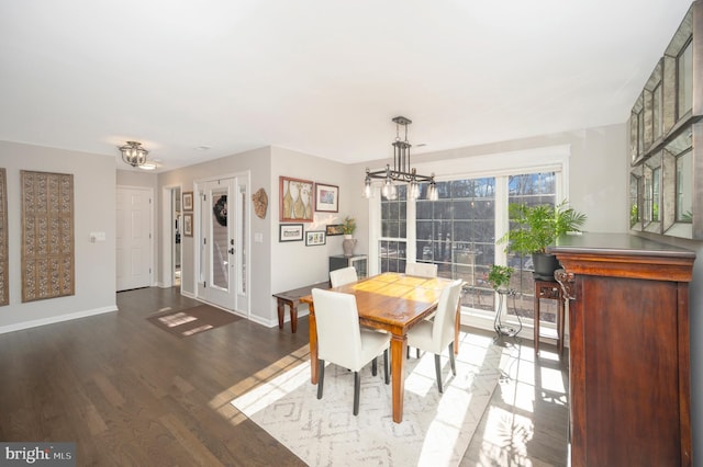 dining area with an inviting chandelier and hardwood / wood-style flooring