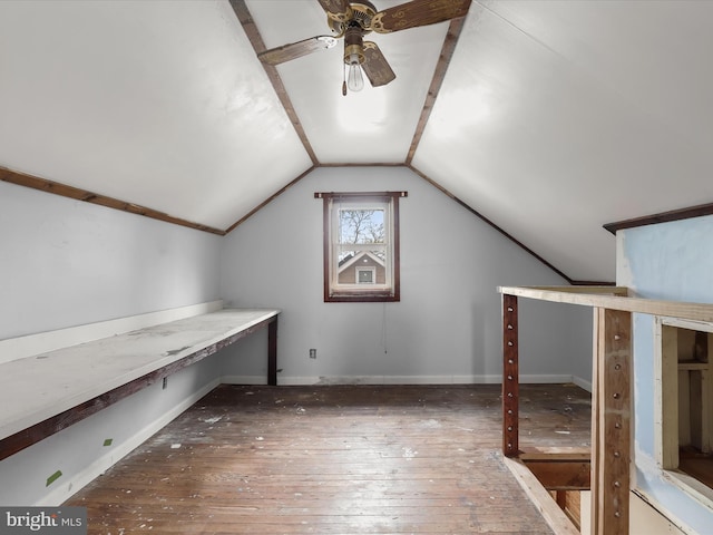 additional living space with ceiling fan, lofted ceiling, and dark hardwood / wood-style flooring