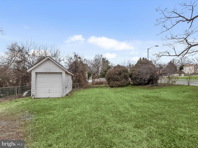 view of yard featuring an outbuilding and a garage