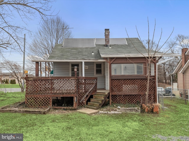 back of house featuring a yard and a deck