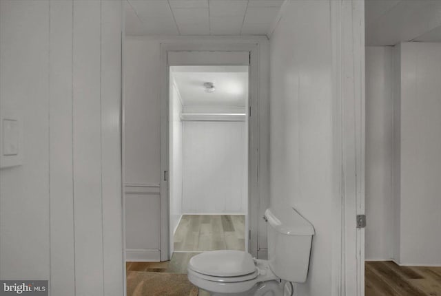 bathroom featuring wood-type flooring and toilet