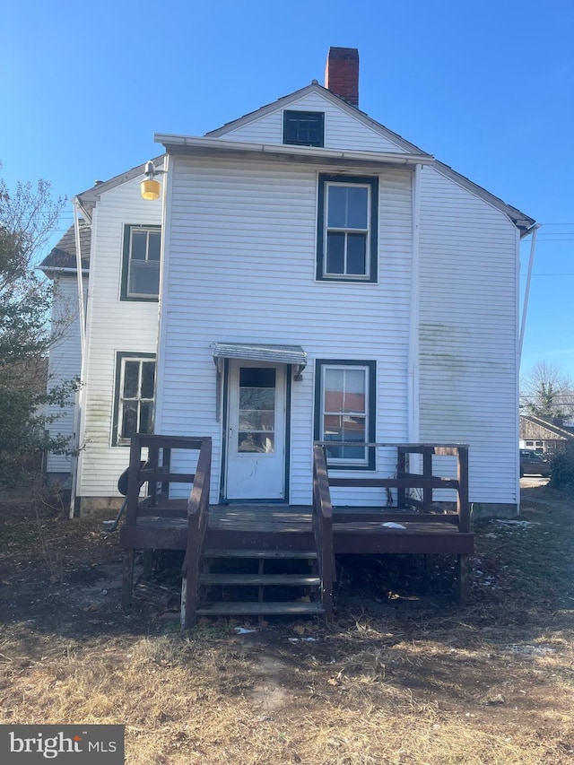 rear view of property featuring a deck