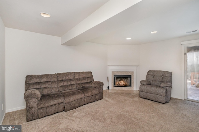 carpeted living room featuring a high end fireplace