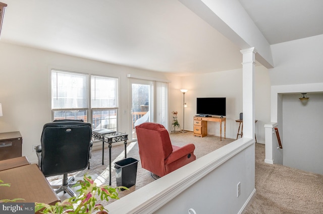 living room with light carpet and decorative columns