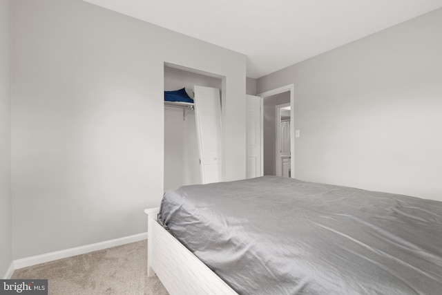 bedroom with a closet, carpet, and baseboards