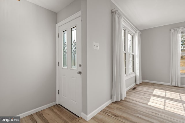 entryway featuring visible vents, light wood-style flooring, and baseboards