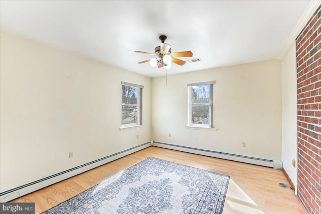 spare room with baseboard heating, ceiling fan, and light hardwood / wood-style floors